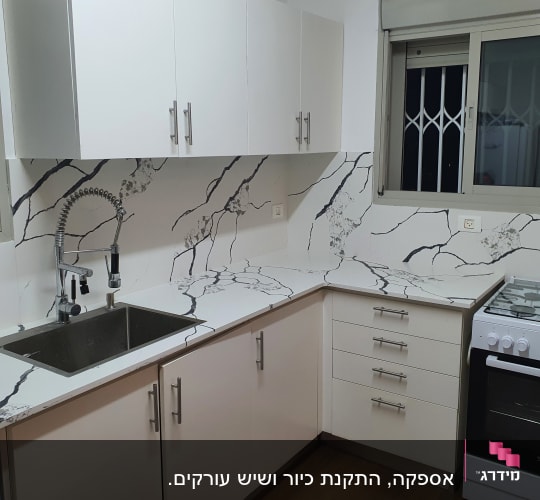 משטח שיש לבן עם עורקים כהים במטבח מודרני
